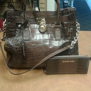 Brown leather Michael Kora purse ad wallet
